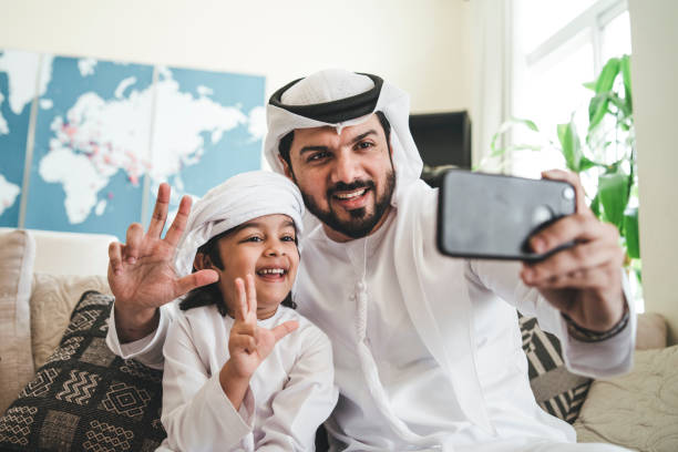 istock Arab man taking a selfie with his son on the sofa at home 1092713290