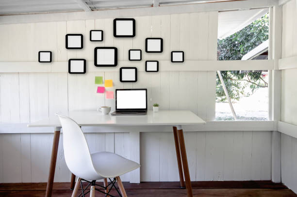 istock creative home office interior with laptop blank screen, picture frame, chair, cup coffee, flower pot on desk 1092713612