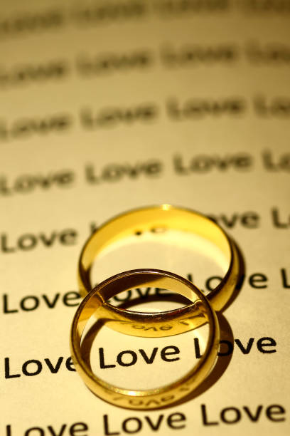 istock Gold wedding rings on an open book 1092718278