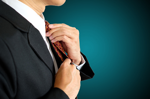 Businessman set his necktie on isolated background with clipping path.