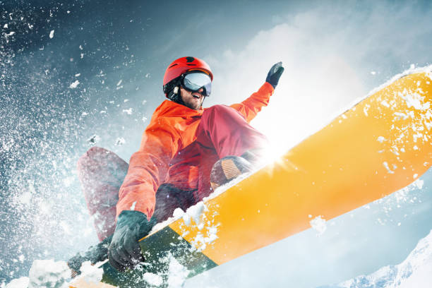 istock Snowboarder jumping through air with deep blue sky in background 1092719708