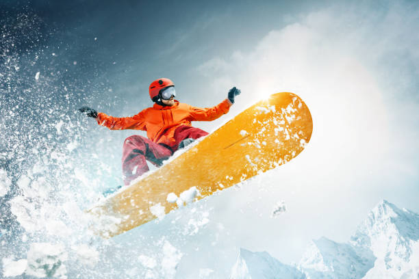 istock Snowboarder jumping through air with deep blue sky in background 1092719716