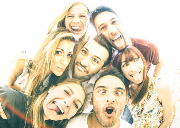 istock Happy best friends taking selfie outdoors with backlighting - Friendship concept with young people having fun together - Warm vintage filter with focus on face expressions and soft sunshine halo flare 1092720536