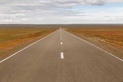 asphalt road Sainshand Zamiin-Uud in Mongolia, beautiful landscape Gobi Desert