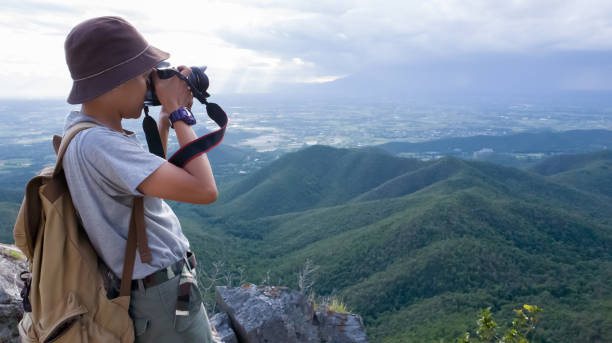 istock Photographer using Camera DSLR, Digital Single Lens Reflex take a photo Mountain and blue sky. Traveling Concept. Hiker concept. 1092723960