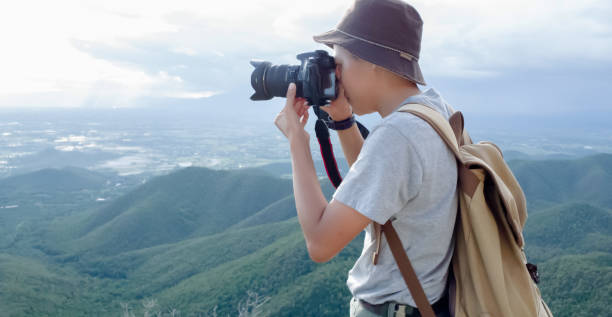 istock Photographer using Camera DSLR, Digital Single Lens Reflex take a photo Mountain and blue sky. Traveling Concept. Hiker concept. 1092724348