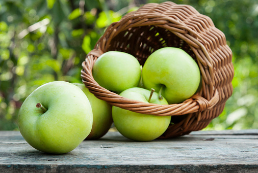 fresh green apples on garden table
