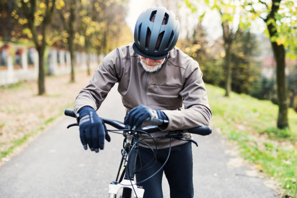istock Active senior man with electrobike standing outdoors on a road in nature. 1092725106