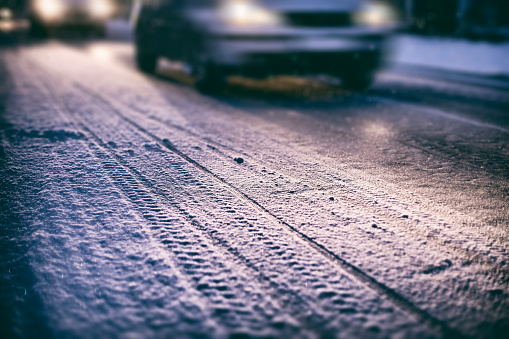 Cars on a snowy road at night