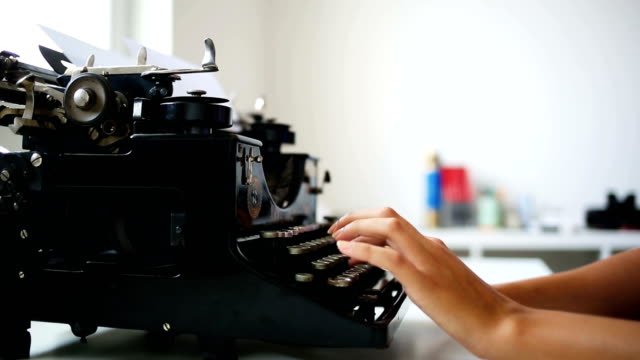 Writer typing with retro typewriter