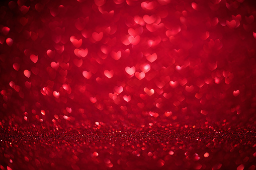 St. Valentine's Day red bokeh background with love heart, place for text.