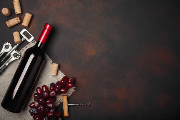 bottle of wine, corkscrew and corks, on rusty background top view - fruit freshness tree foods and drinks imagens e fotografias de stock