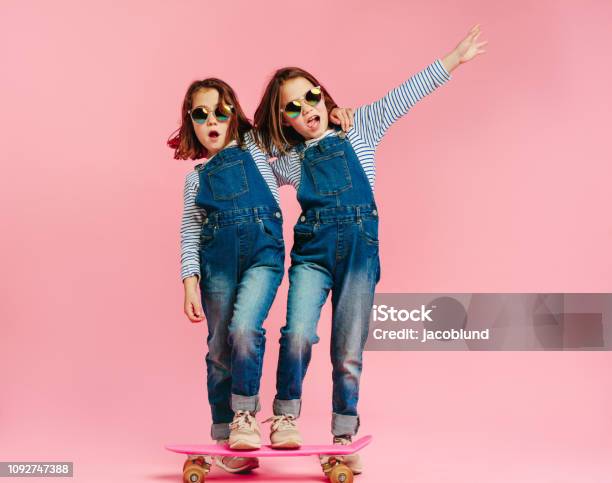 Stylish Cute Girls With Skateboard Stock Photo - Download Image Now - Child, Twin, Fashion