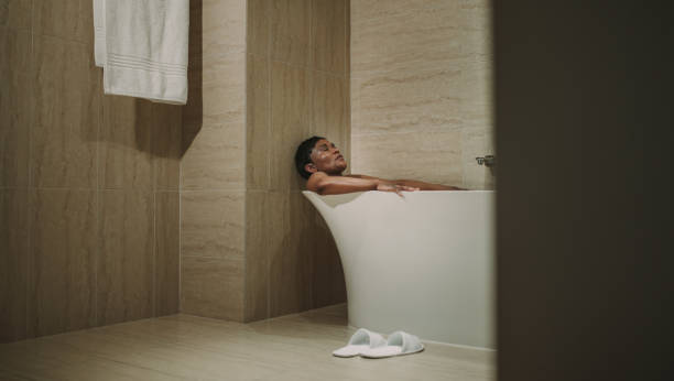 Female relaxing in bathtub with her eyes closed