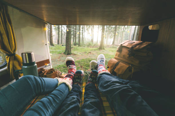 Family laying in camper van in Christmas socks Family with little boy laying in camper van in Christmas socks rv travel stock pictures, royalty-free photos & images