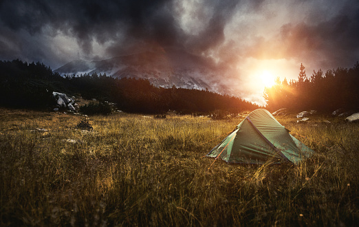 Camping in a Tent in the Mountains at Sunset