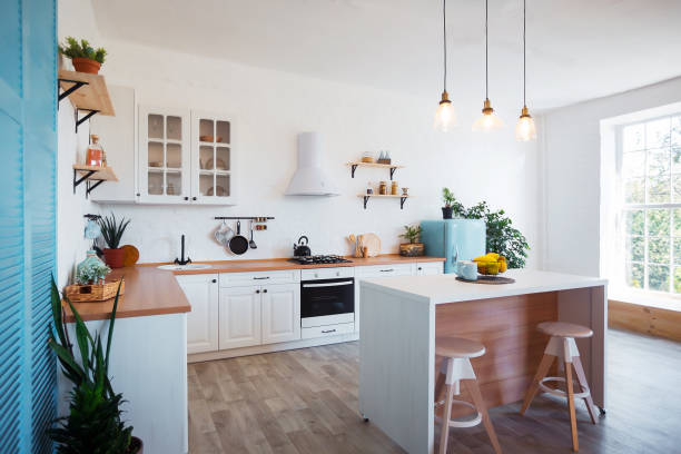 modern kitchen interior with island, sink, cabinets, and big window in new luxury home. - home accessories imagens e fotografias de stock