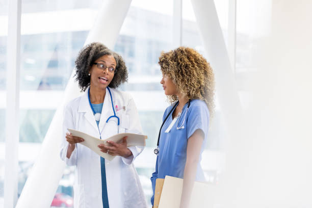 istock Mature doctor has serious conversation with nurse 1092758408