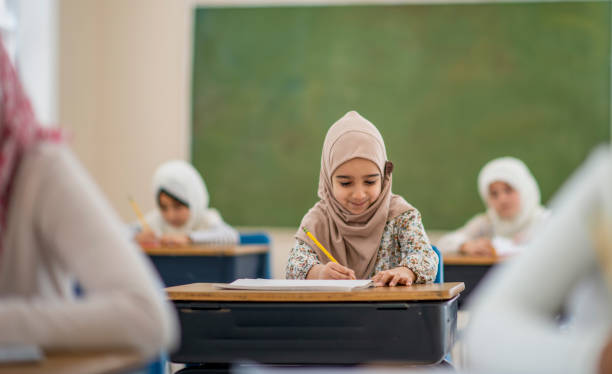 istock Smiling muslim girl writing 1092760880