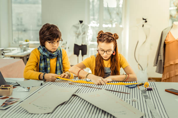 istock Children helping their mother who is designer to draft patterns 1092764820