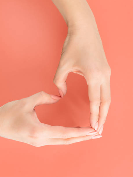 istock Woman hands making heart sign on red 1092767454