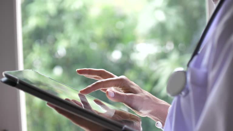 Senior Female Woman doctor using tablet pc, Slow motion