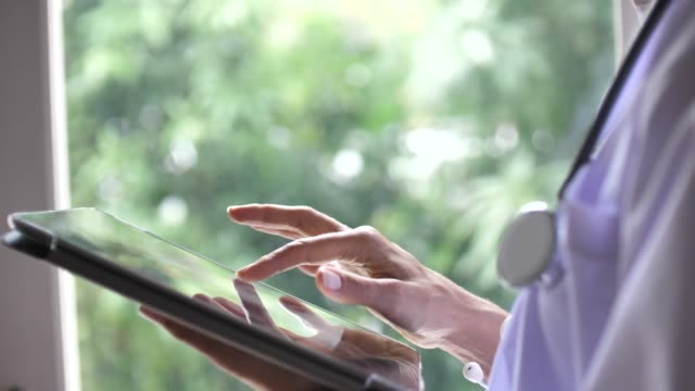 Senior Female Woman doctor using tablet pc, Slow motion