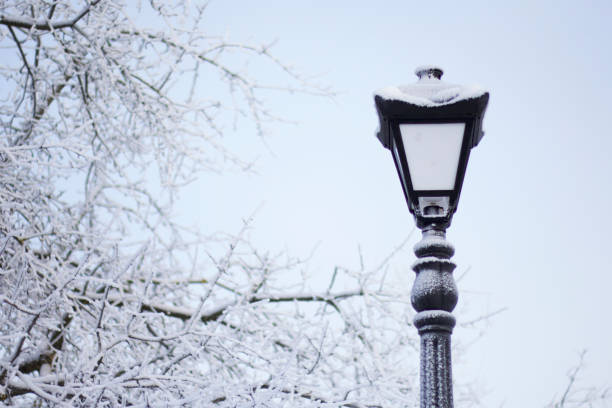 istock Old-fashioned lantern in a winter park. Everything around is covered with thick frost. 1092769918