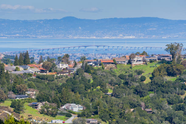Residential neighborhood on the hills of San Francisco peninsula, Silicon Valley, San Mateo bridge in the background, California Residential neighborhood on the hills of San Francisco peninsula, Silicon Valley, San Mateo bridge in the background, California redwood city stock pictures, royalty-free photos & images