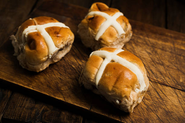 istock Three Hot cross buns on an aged wood surface. 1092773324