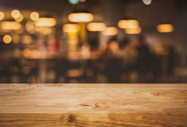 istock Wood texture table top (counter bar) with blur light gold bokeh in cafe,restaurant background.For montage product display or design key visual 1092776094