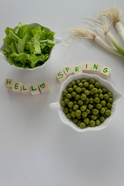 Fresh raw spring vegetables on white background, text " Hello spring"