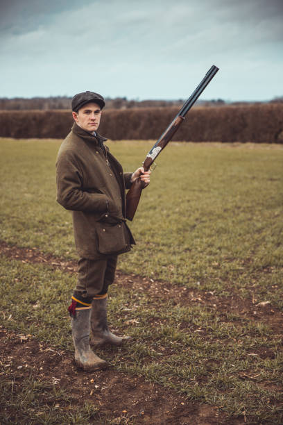istock Hunter posing with shotgun in field 1092790426