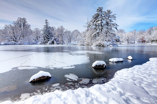 View of the frozen lake of Limides with the reflection of the snowy peak of Lagazuoi in the ice cracks, Dolomites, Passo Falzarego, Veneto, Belluno province, Italy, Europe