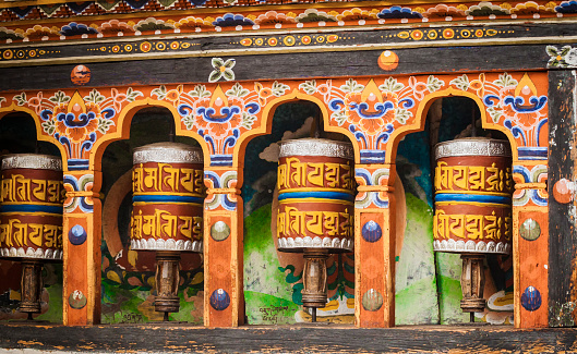 Turning prayer wheels mantra in Bhutan with traditional writing mantra which sounds as 