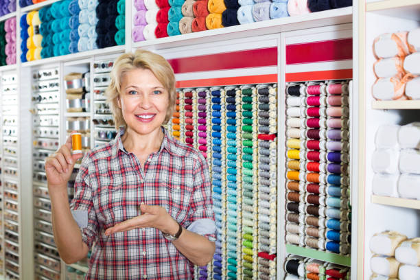 istock mature woman in sewing store 1092794878