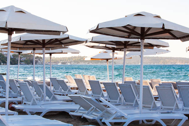 istock Beach chairs with beach umbrellas in a seashore on a sunny day. 1092800238