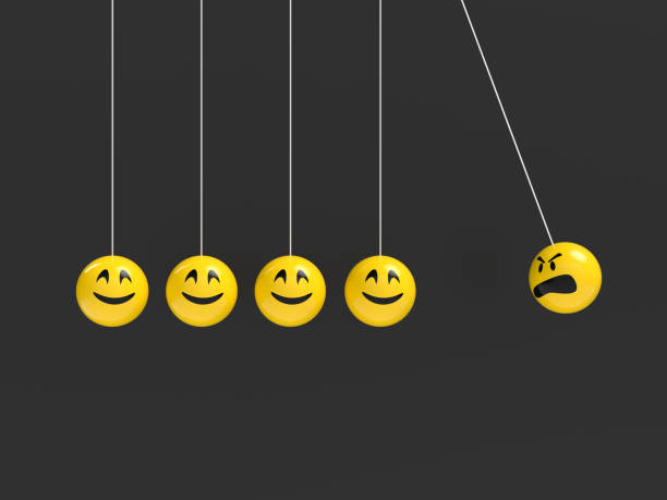 istock Anger Concept With Happy and Angry Faces on Newton’s Cradle on Black Background 1092802128