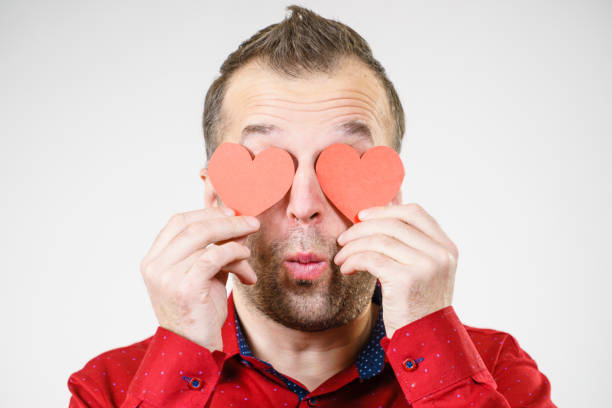 istock Man in love with hearts on eyes 1092808464
