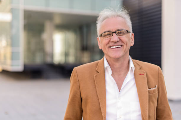 istock Happy mature man standing in front of office building. 1092811938