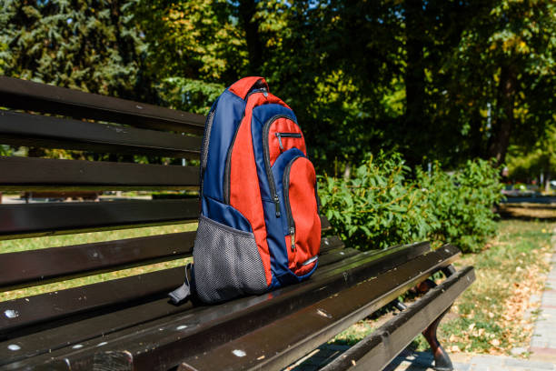istock Tourist backpack on a bench in city park 1092814228