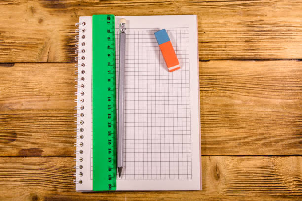 istock Open notepad, ruler and pencil on a wooden table. Top view 1092814312