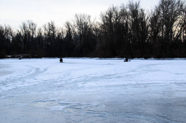 istock Winter fishing on a frozen river 1092814642
