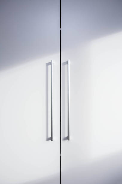 istock White closet doors wood closeup with shadows 1092815604