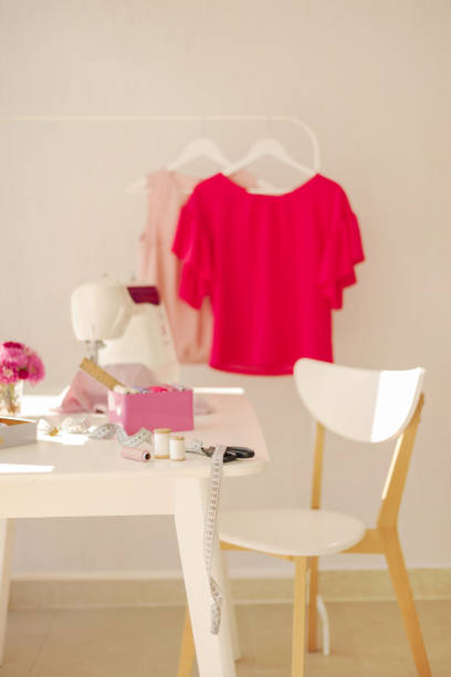 istock Workplace for sewing and needlework in a bright room with white furniture. 1092818324