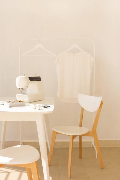 istock Workplace for sewing and needlework in a bright room with white furniture. 1092818334