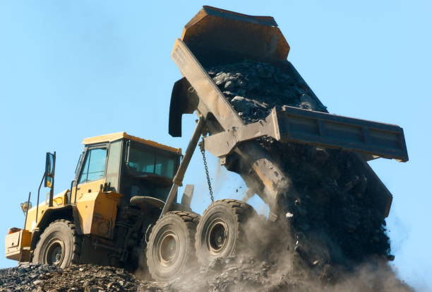 istock truck dumping rock on blue sky background 1092821802