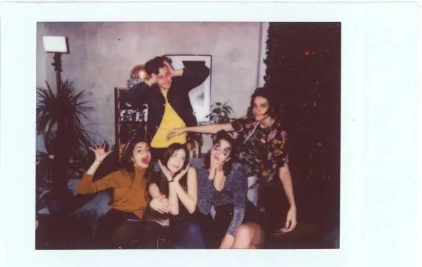 Group of friends posing for polaroid party photo