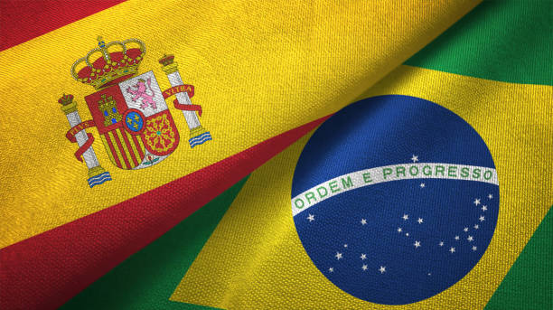 istock Brazil and Spain two flags together realations textile cloth fabric texture 1092847402