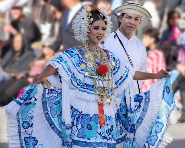 Panamanian couple at the Rose Parade Young Panamanian couple dancing during the Tournament of Roses in Pasadena. The woman is wearing a traditional Panamanian folklore dress or 'Pollera' and jewelry. traditional clothing stock pictures, royalty-free photos & images